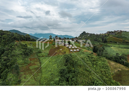 An aerial photographic view of Mon Jam Village in Chiangmai, filled with houses, resorts, and homestays for all the visitors. An aerial photographic view of Mon Jam Village in Chiangmai, filled with houses, resorts, and homestays for all the visitors. 108867998