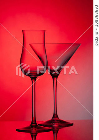 Empty glass wine glass on a red background. Empty glass wine glass on a red background. 108868693