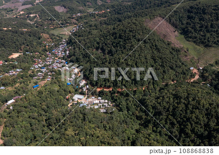 High angle view of a northern rural village in the valley Ban Thung Ton Ngio, Mae Tuen, Omkoi district, Chiang Mai, Thailand. High angle view of a northern rural village in the valley Ban Thung Ton Ngio, Mae Tuen, Omkoi district, Chiang Mai, Thailand. 108868838