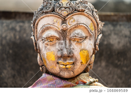 Vintage Stone Traditional Statue in Woman Character at backside of Wat Phra That Chom Kitti, a worship place at Chiang Rai, Thailand. Vintage Stone Traditional Statue in Woman Character at backside of Wat Phra That Chom Kitti, a worship place at Chiang Rai, Thailand. 108869589