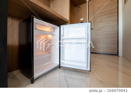 Opened small refrigerator under the wood counter and in front of enter door delux room at resort and hotel. Opened small refrigerator under the wood counter and in front of enter door delux room at resort and hotel. 108870041
