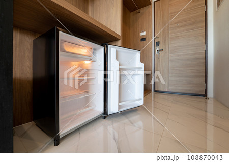 Opened small refrigerator under the wood counter and in front of enter door delux room at resort and hotel. Opened small refrigerator under the wood counter and in front of enter door delux room at resort and hotel. 108870043