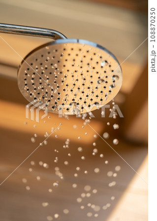 Close up to Outdoor shower head for the bath and showering cold water to body before jumping in the resort pool. Close up to Outdoor shower head for the bath and showering cold water to body before jumping in the resort pool. 108870250