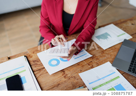 Young asian female work with financial papers at home count on calculator before paying taxes receipts online, planning budget glad to find chance for economy saving money, audit concepts. Young asian female work with financial papers at home count on calculator before paying taxes receipts online, planning budget glad to find chance for economy saving money, audit concepts. 108875787
