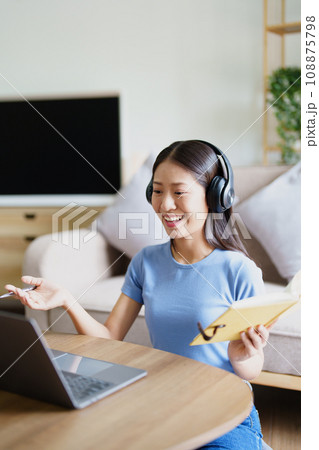 Studying online, beautiful Asian female student or student studying online at home. 108875798