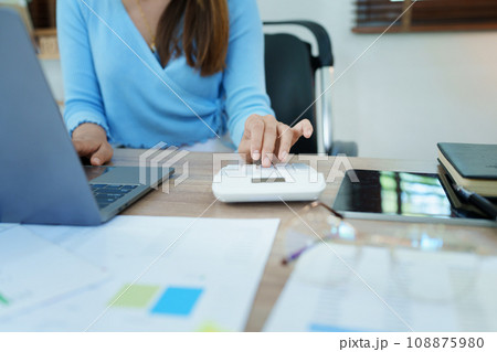 Accountants, Asian auditors are using calculators and computers to review annual tax budgets to submit information to the IRS 108875980