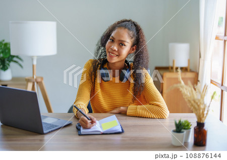 Portrait of African Americans using notebooks, pens to take notes and computers. to study through the Internet, online e learning concept 108876144