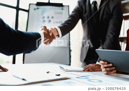 Asian entrepreneurs handshakes to congratulate the agreement between the two companies to enhance investment and financial strength. deal concept. Asian entrepreneurs handshakes to congratulate the agreement between the two companies to enhance investment and financial strength. deal concept. 108876420