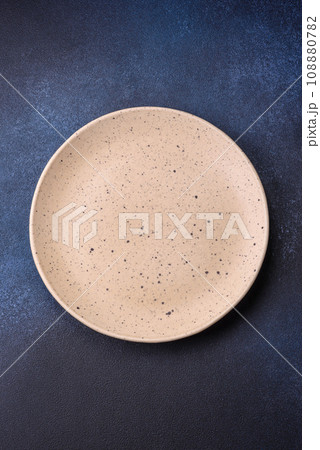 Round empty colored ceramic plate on concrete texture background 108880782