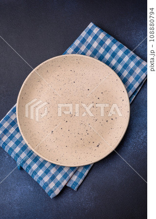 Round empty colored ceramic plate on concrete texture background Round empty colored ceramic plate on concrete texture background 108880794
