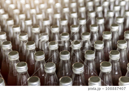 Juice in glass bottles in factory to fill with drink. 108887407