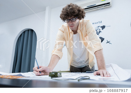 young architect man working drawing house design plan project. young architect man working drawing house design plan project. 108887917
