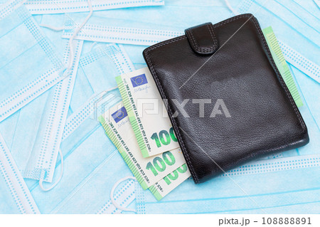 Black Men's Wallet with Euro Money Inside on the Blue Disposable Medical Face Masks Black Men's Wallet with Euro Money Inside on the Blue Disposable Medical Face Masks 108888891