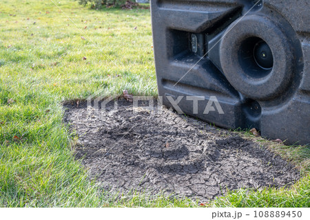 Dead grass under area that basketball stand that has been in one spot.  108889450