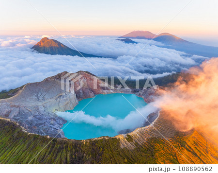 Aerial view of rock cliff at Kawah Ijen volcano with turquoise sulfur water lake at sunrise.Amazing nature landscape view at East Java, Indonesia.Natural landscape colorful sky background Aerial view of rock cliff at Kawah Ijen volcano with turquoise sulfur water lake at sunrise.Amazing nature landscape view at East Java, Indonesia.Natural landscape colorful sky background 108890562