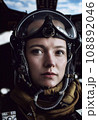 A military fighter pilot in the cockpit of his plane, wearing a helmet and goggles. 3D rendering. 108892046