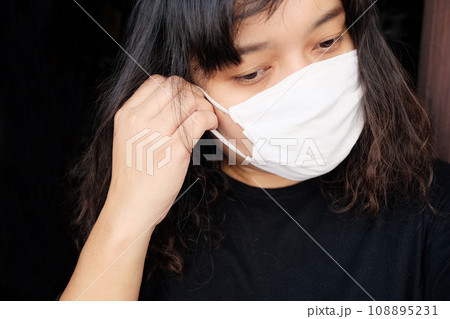 Asian Thai woman wearing a white cloth mask for prevent the Covid-19 or Corona virus and Air Pollution Value Pm 2.5 in Thailand and Epidemic disease around the world. Health and illnes 108895231