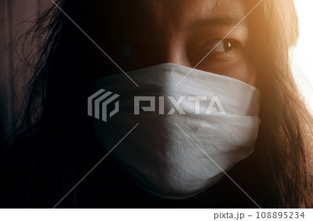 Asian Thai woman wearing a white cloth mask for prevent the Covid-19 or Corona virus and Air Pollution Value Pm 2.5 in Thailand and Epidemic disease around the world. Health and illnes Concept Asian Thai woman wearing a white cloth mask for prevent the Covid-19 or Corona virus and Air Pollution Value Pm 2.5 in Thailand and Epidemic disease around the world. Health and illnes Concept 108895234