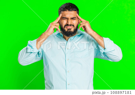 Indian man rubbing temples to cure headache problem, suffering from tension and migraine stress pain Indian man rubbing temples to cure headache problem, suffering from tension and migraine stress pain 108897181