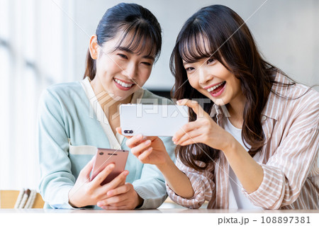 スマホを見る女子大生 108897381