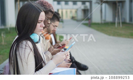 Digital Connection: young students absorbed in their virtual worlds Digital Connection: young students absorbed in their virtual worlds 108899253