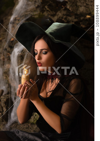 A portrait of a young sexy witch with outside. Magic, dark force, spell. Witchcraft. Halloween. A portrait of a young sexy witch with outside. Magic, dark force, spell. Witchcraft. Halloween. 108899444