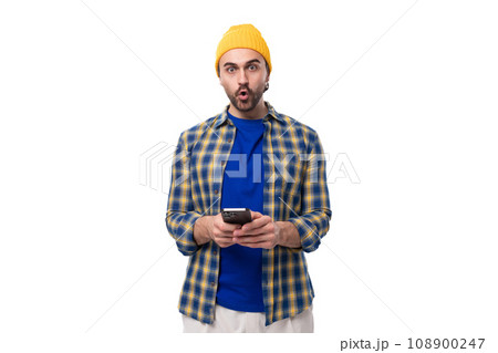 young stylish emotional brunette man with a brutal beard and mustache in a hat and shirt looks at young stylish emotional brunette man with a brutal beard and mustache in a hat and shirt looks at 108900247