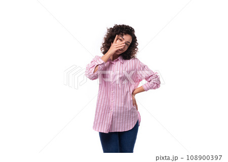 portrait of a young slender caucasian leader woman dressed in a pink striped oversized shirt 108900397