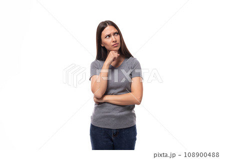 young well-groomed brunette woman in a gray t-shirt with a mock-up for an identity on a white 108900488