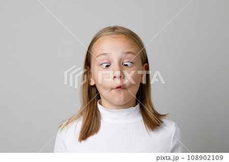 Cheerful child making funny face. Pretty preschool girl portrait Cheerful child making funny face. Pretty preschool girl portrait 108902109