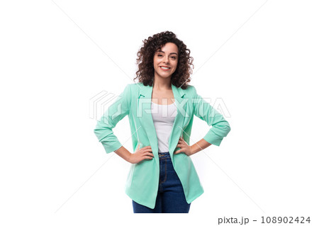 charming well-groomed young brunette curly businesswoman in a blue jacket on a white background 108902424