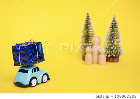Mother, daughter, and son eagerly await their father return for Christmas with present 108902585