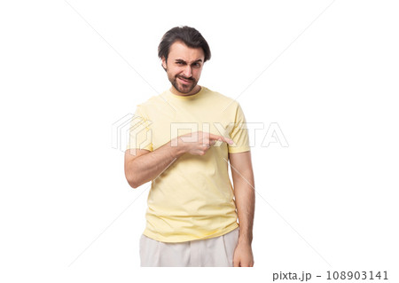 young well-groomed european brunette guy with a beard and mustache points his hand to the side young well-groomed european brunette guy with a beard and mustache points his hand to the side 108903141