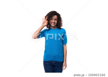 young brunette lady with curly hair is dressed in a blue blouse and shows ok 108903160
