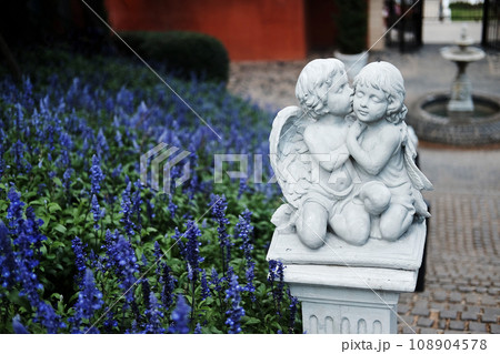 White children couple and lover angle marble statue of roman decorated in the flowers garden 108904578