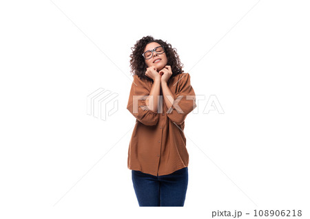 young positive cheerful slender woman with curls dressed in a brown blouse 108906218