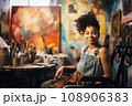Portrait of disabled female artist on wheelchair in art studio 108906383
