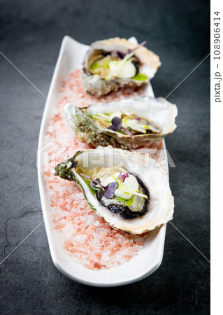 Grilled oysters on red sea salt with lime Grilled oysters on red sea salt with lime 108906414