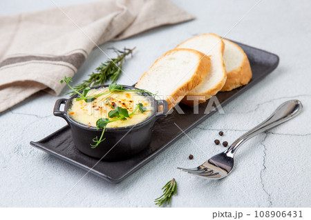 Julienne in a mug with pieces of bread 108906431