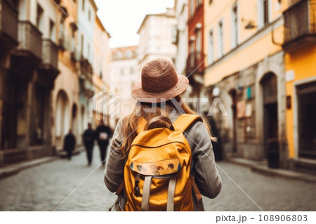View of a female tourist with a backpack. Guide, tourism in Europe 108906803