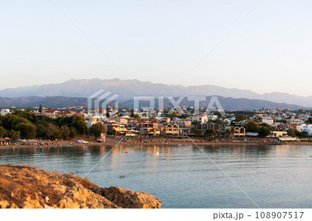 Cityscape at sunset, Agioi Apostoli, Chania, Crete, Greece. 108907517