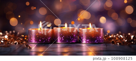lit candles on a dark background with bokeh glow 108908125
