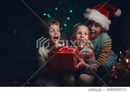 happy family with Merry Christmas magic gift near tree at evening at home 108908511