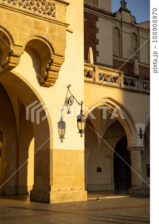 The Cloth Hall Sukiennice in Krakow, Main Market Square in the Old Town district, Poland. UNESCO World Heritage Site of Cracow. Antique street lighting lantern on the wall of the house 108908970