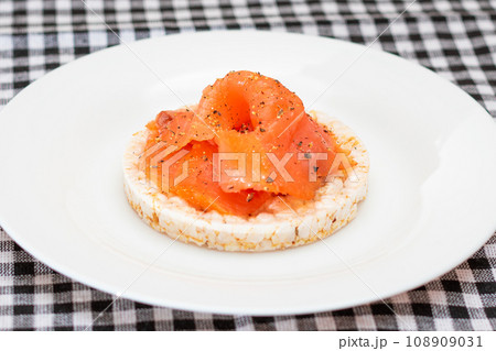 Rice Cake Sandwich with Fresh Salmon Slices on White Plate Rice Cake Sandwich with Fresh Salmon Slices on White Plate 108909031