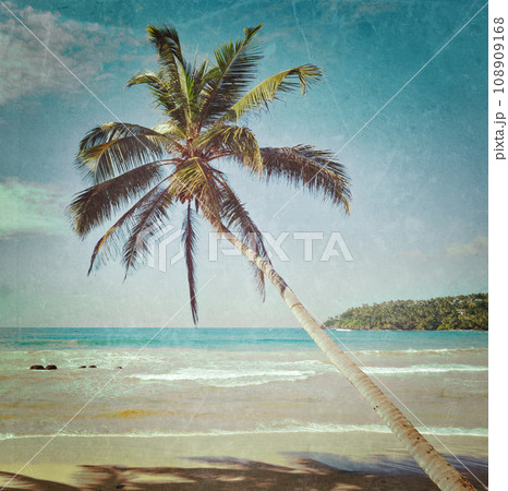 Vintage retro hipster style travel image of tropical paradise idyllic beach with palm with grunge texture overlaid. Sri Lanka Vintage retro hipster style travel image of tropical paradise idyllic beach with palm with grunge texture overlaid. Sri Lanka 108909168