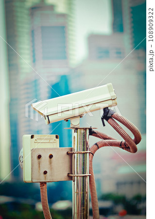 CCTV surveillance camera in Singapore with skyscapers in background CCTV surveillance camera in Singapore with skyscapers in background 108909322