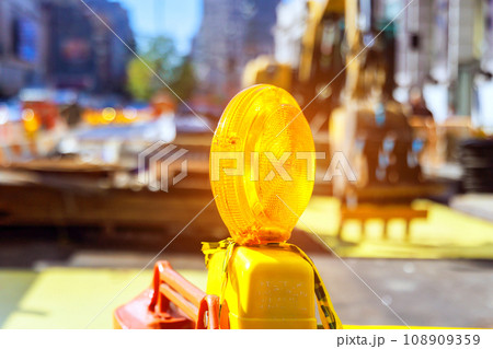 Close up of yellow warning orange construction light on barricade intended to warn construction site. 108909359