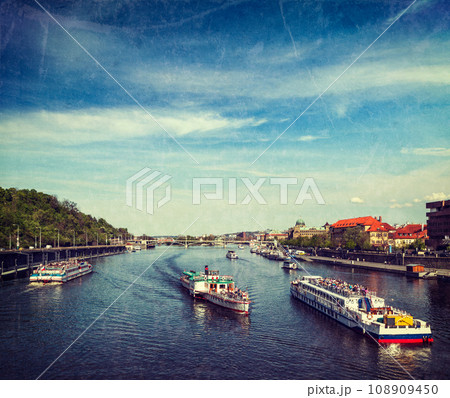 Vintage retro hipster style travel image of turist boats on Vltava river in Prague, Czech Republic with grunge texture overlaid Vintage retro hipster style travel image of turist boats on Vltava river in Prague, Czech Republic with grunge texture overlaid 108909450