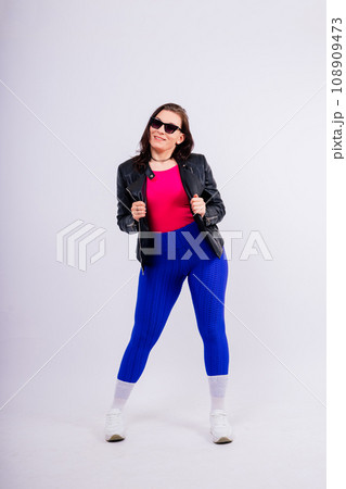 Strong female shows her biceps in fashionable sportswear studio background. Strength and motivation 108909473